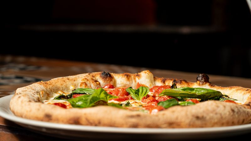 Margherita pizza with fresh basil and tomatoes